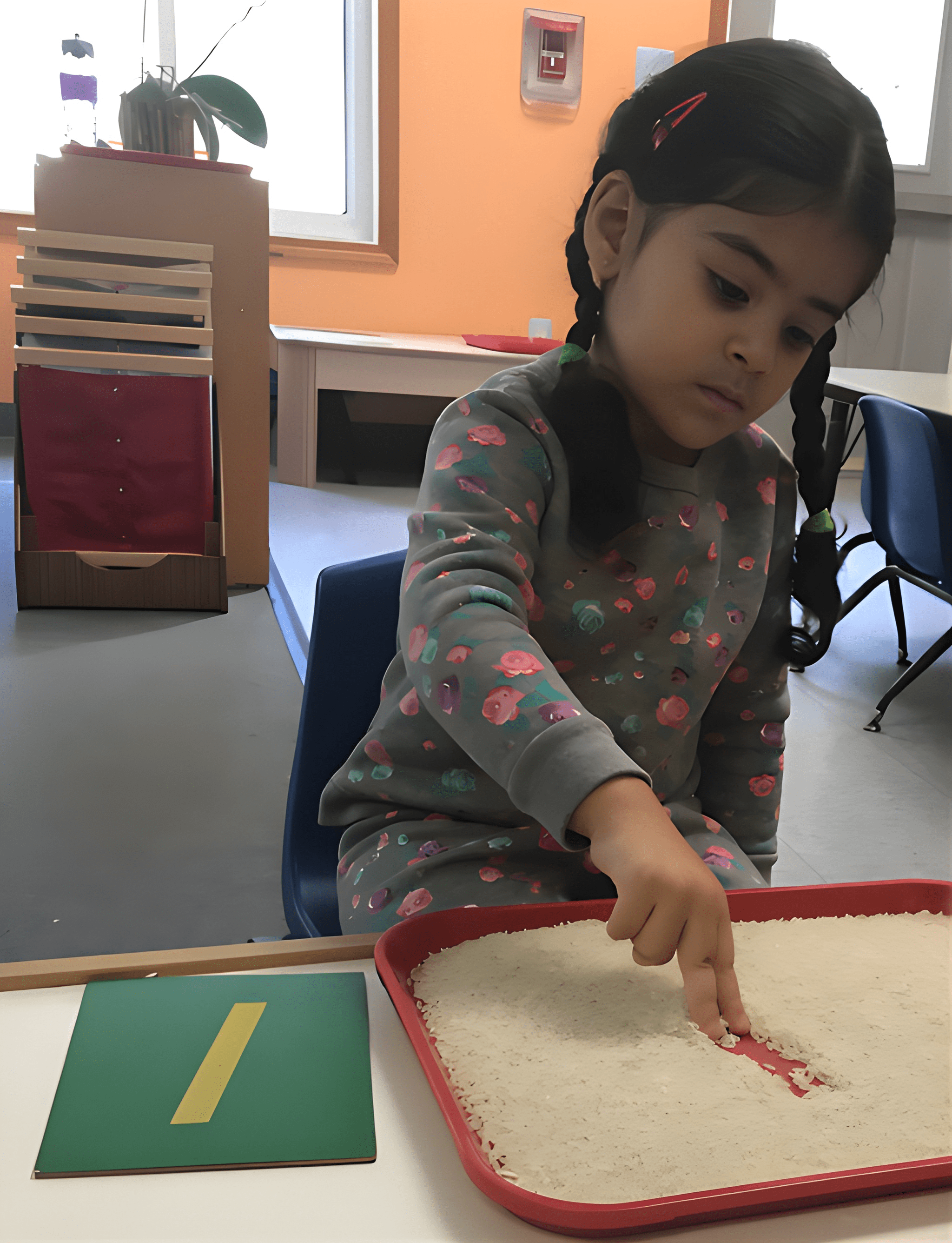 A Canton child writing letters in a sand tray
