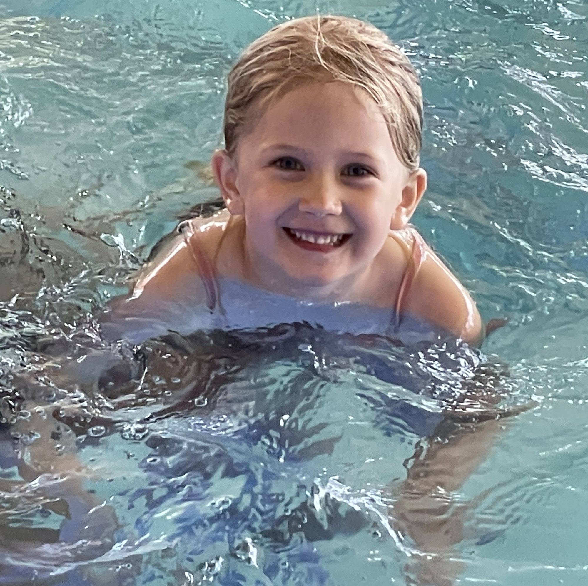Children cooling off and swimming together on a summer afternoon