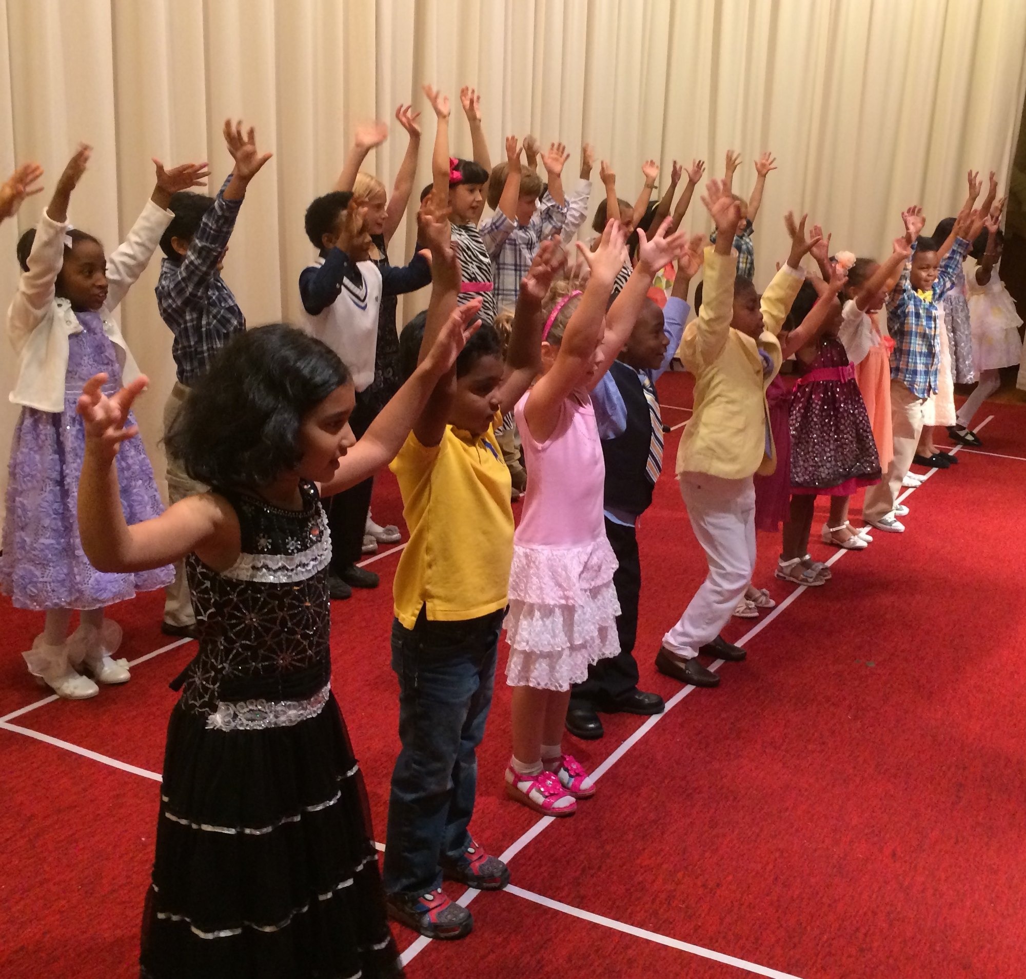 Children dancing in a sunlit studio